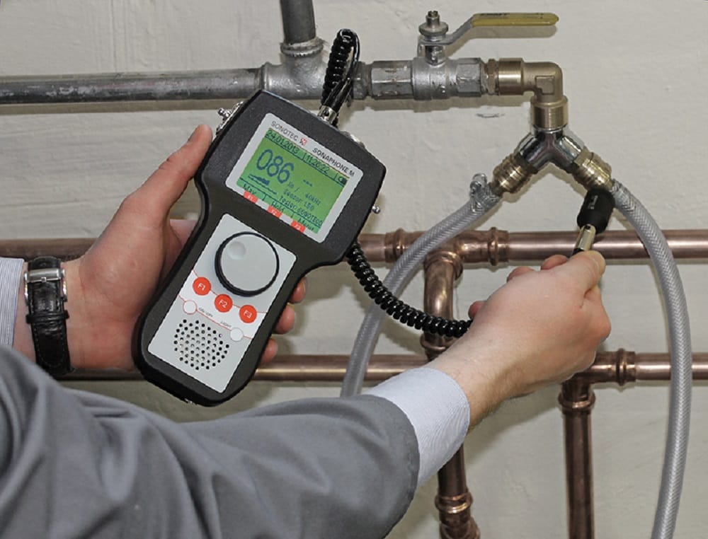 Plumber testing pipes with electronic leak detection equipment in Wildomar