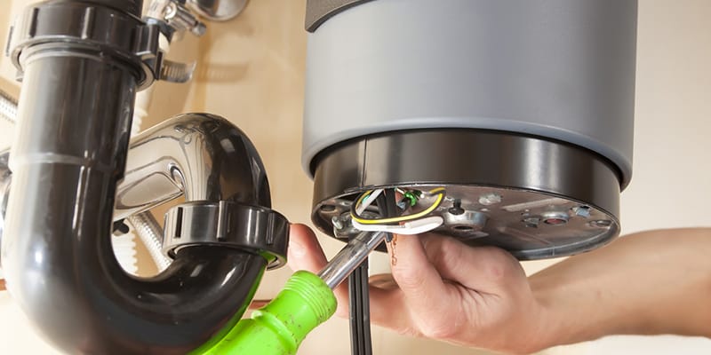 Technician repairing the heating element of a water heater in Wildomar