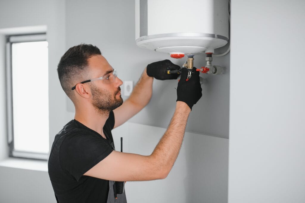 Technician performing water heater maintenance in Wildomar